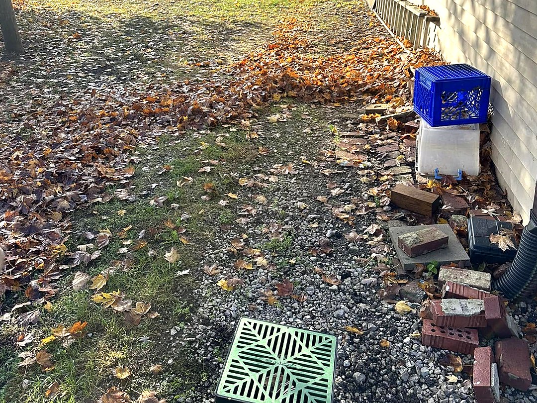 Cleared slope beside a house stripped back to bare soil