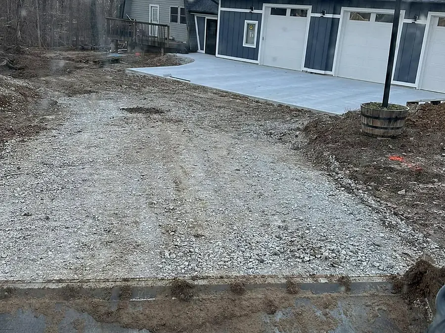 Excavated and graded ground against the foundation of a light grey house