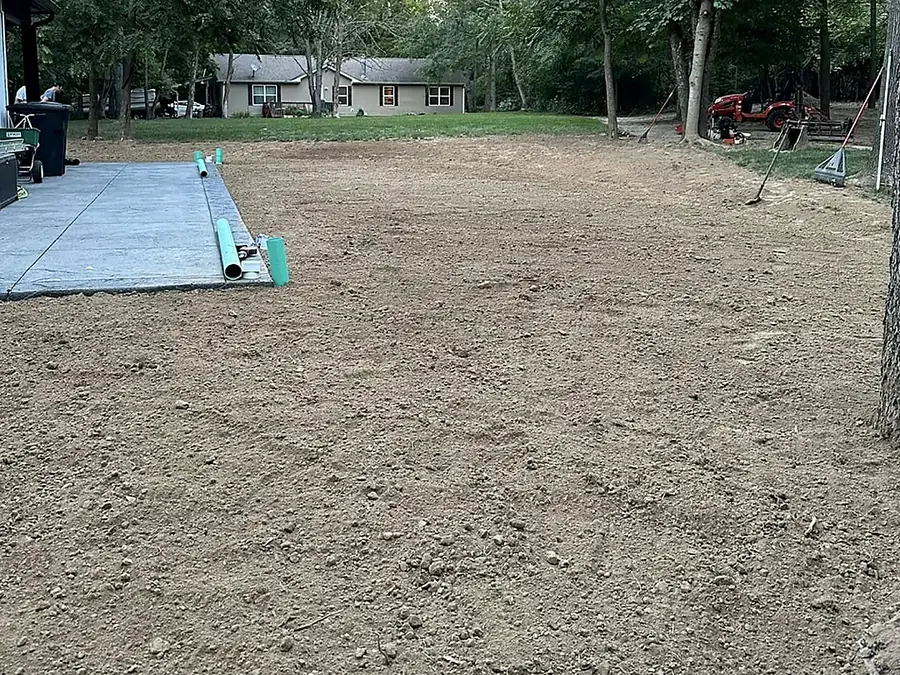 Levelled and compacted pad with materials staged at the edge