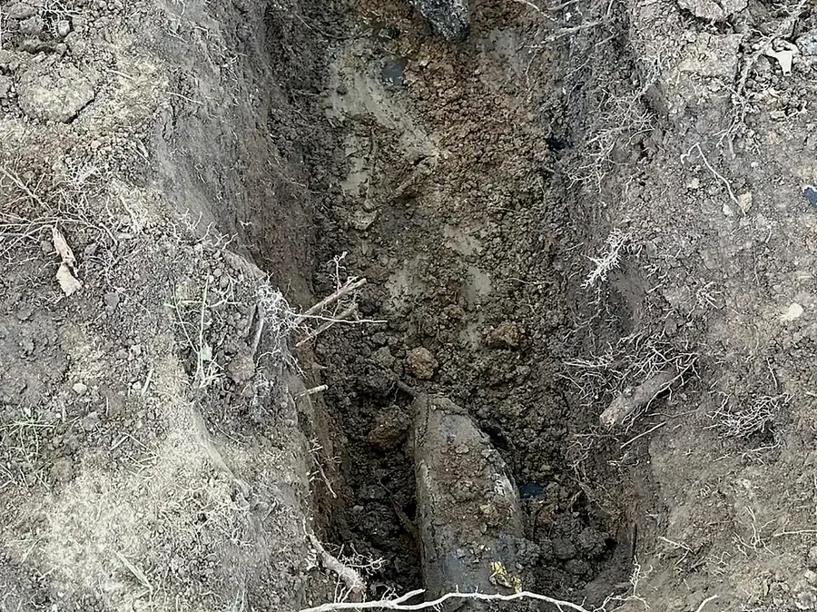 Open trench cut through heavy clay showing bucket teeth marks