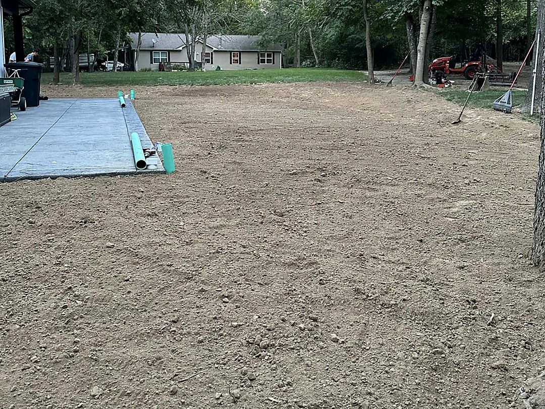 Levelled and compacted pad with materials staged at the edge